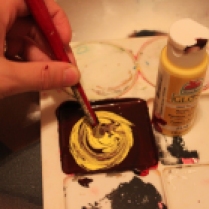 Mix yellow paint in next until you reach your desired brown.