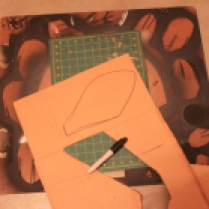 Next, draw and cut out with an exacto knife two ears